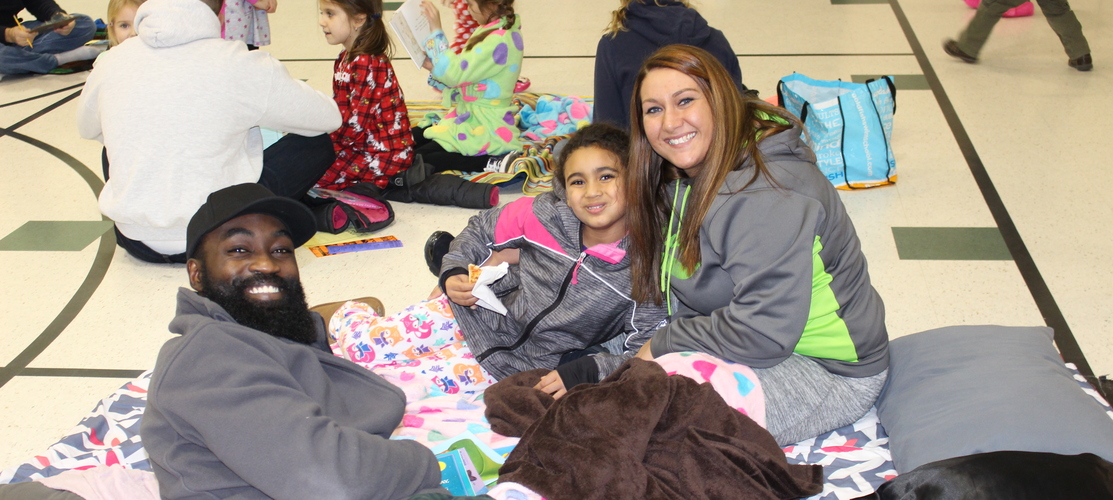 family on blankets at reading night