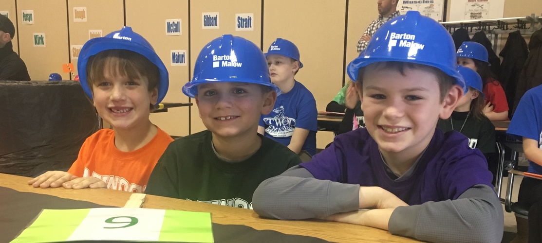 Boys posing in construction hats