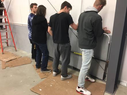Students working on drywall